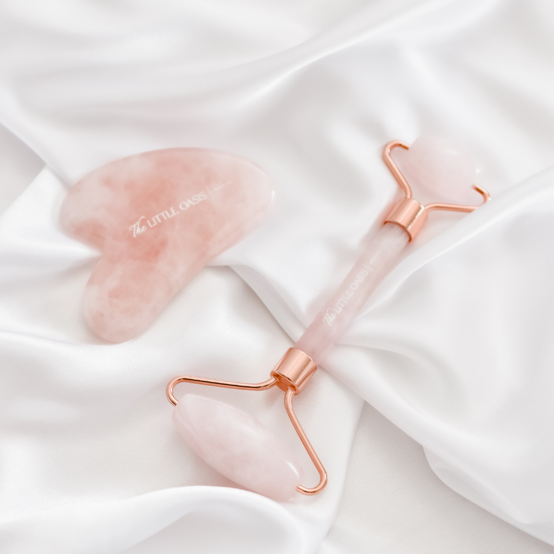 Rose Quartz Gua Sha and Facial Roller Set. Top view, pink colour with rose gold.