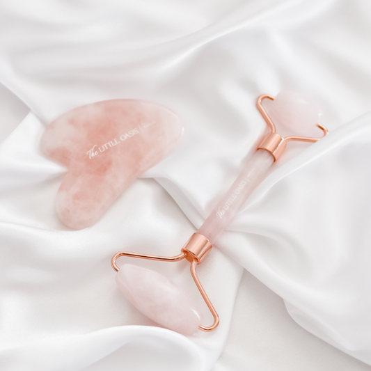 Rose Quartz Gua Sha and Facial Roller Set. Top view, pink colour with rose gold. 